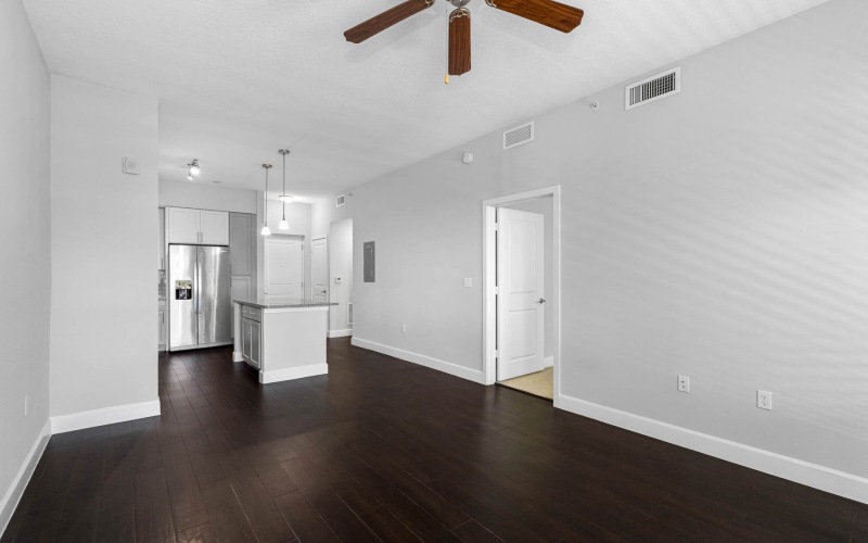 an empty living room with wood floors
