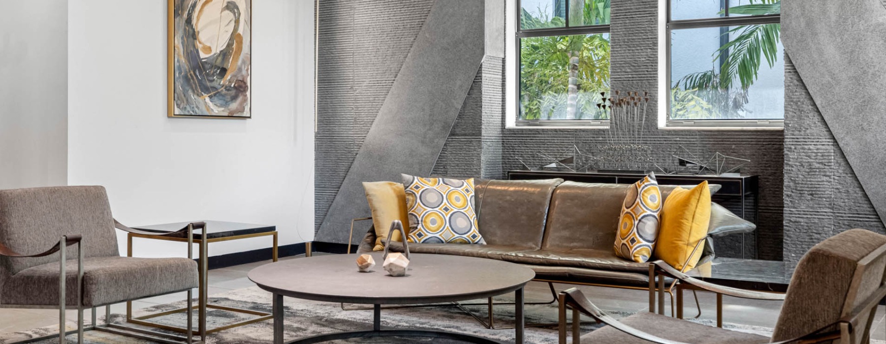 a lounge and a seating area with natural light