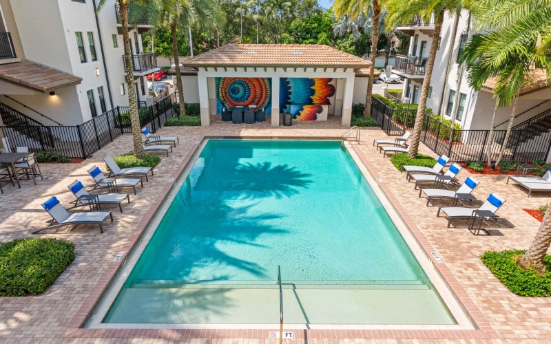 Resort-style swimming pool with lounge seating