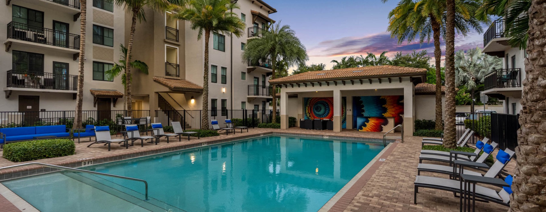 Resort-style swimming pool with lounge seating