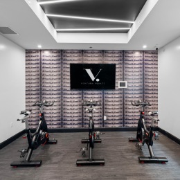 spin bikes and a tv in a fitness area